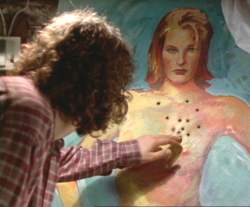 Jonathan looks at the bullet holes in the painting of Francesca