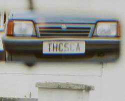 The car numberplate as seen in a mirror - looking like it spells out THE SEA
